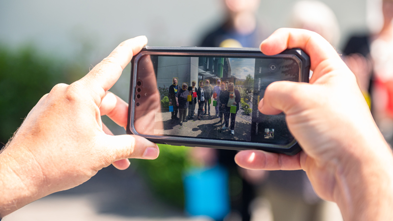 Tai Tarian comms officer photographing tenants