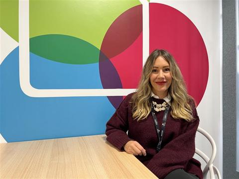 Ana sitting by a table