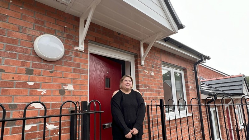 Tenant standing in front of a Clos Castan front door