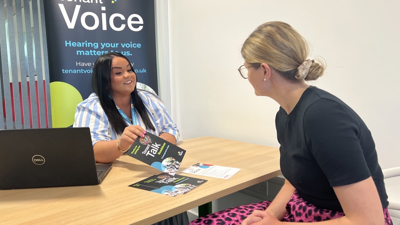 A staff member talking with a tenant
