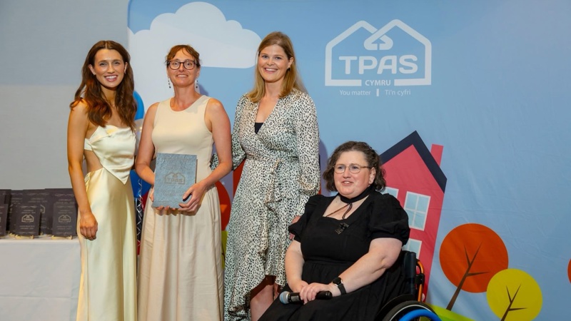 Tai Tarian colleagues holding an award at the TPAS Cymru Good Practice Awards.