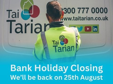 Tai Tarian staff member with a banner below with the headline of bank holiday closing
